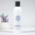 Alpha Beta Toner skincare bottle with silver cap and decorative label, plant in background