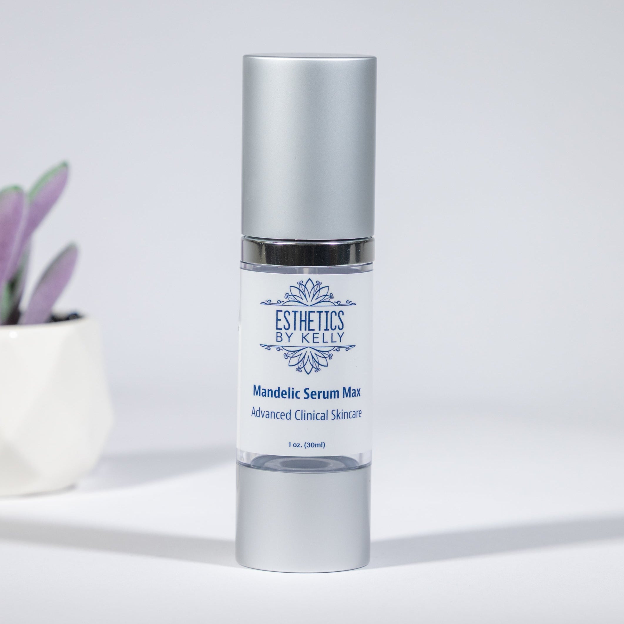 Skincare serum bottle with a small plant on a light background