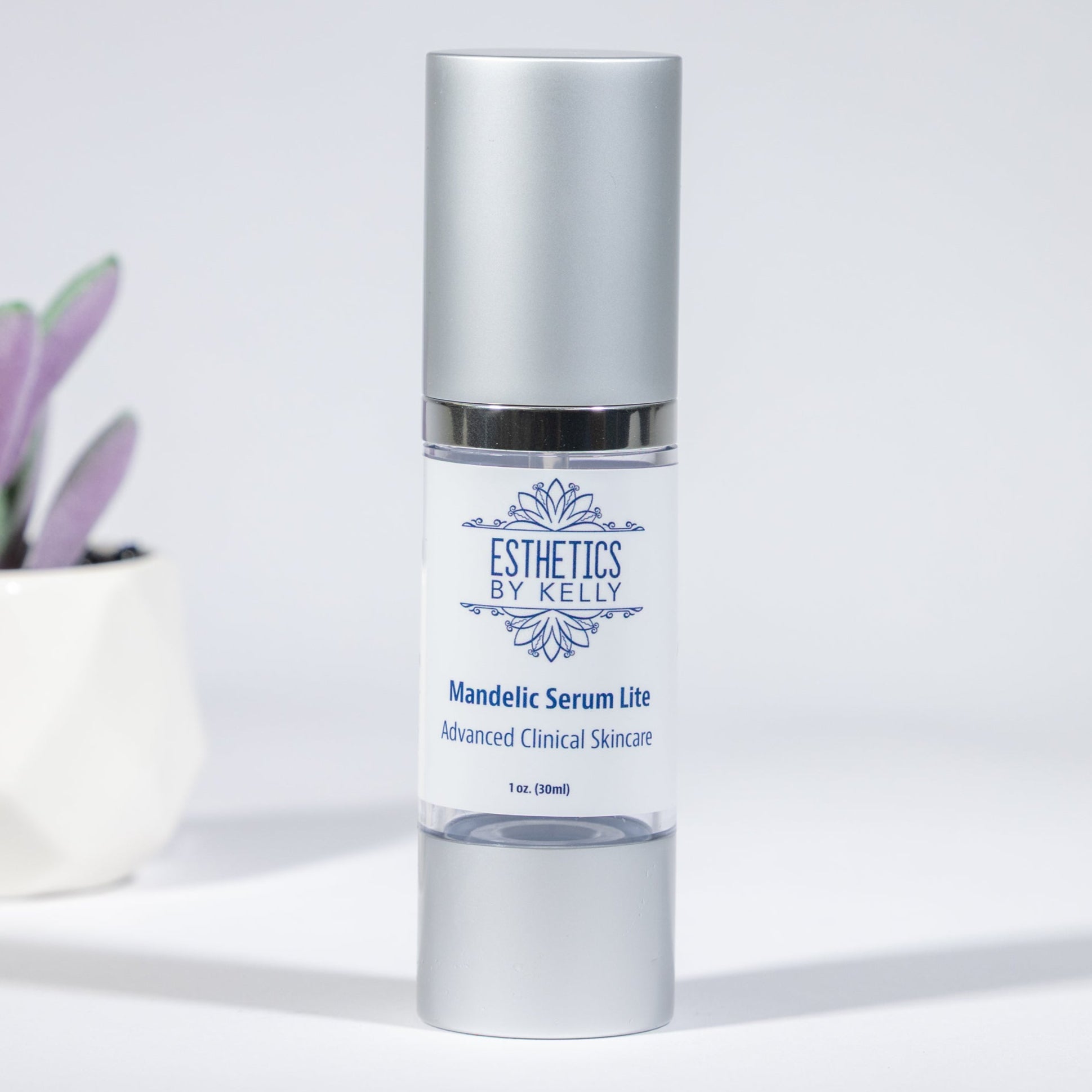 Skincare serum bottle with a small potted plant on a light gray background